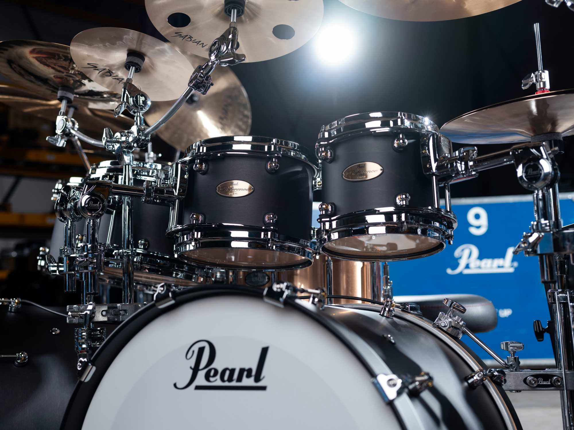 Real drum set that is intended to be played by humans, with transport case in background.