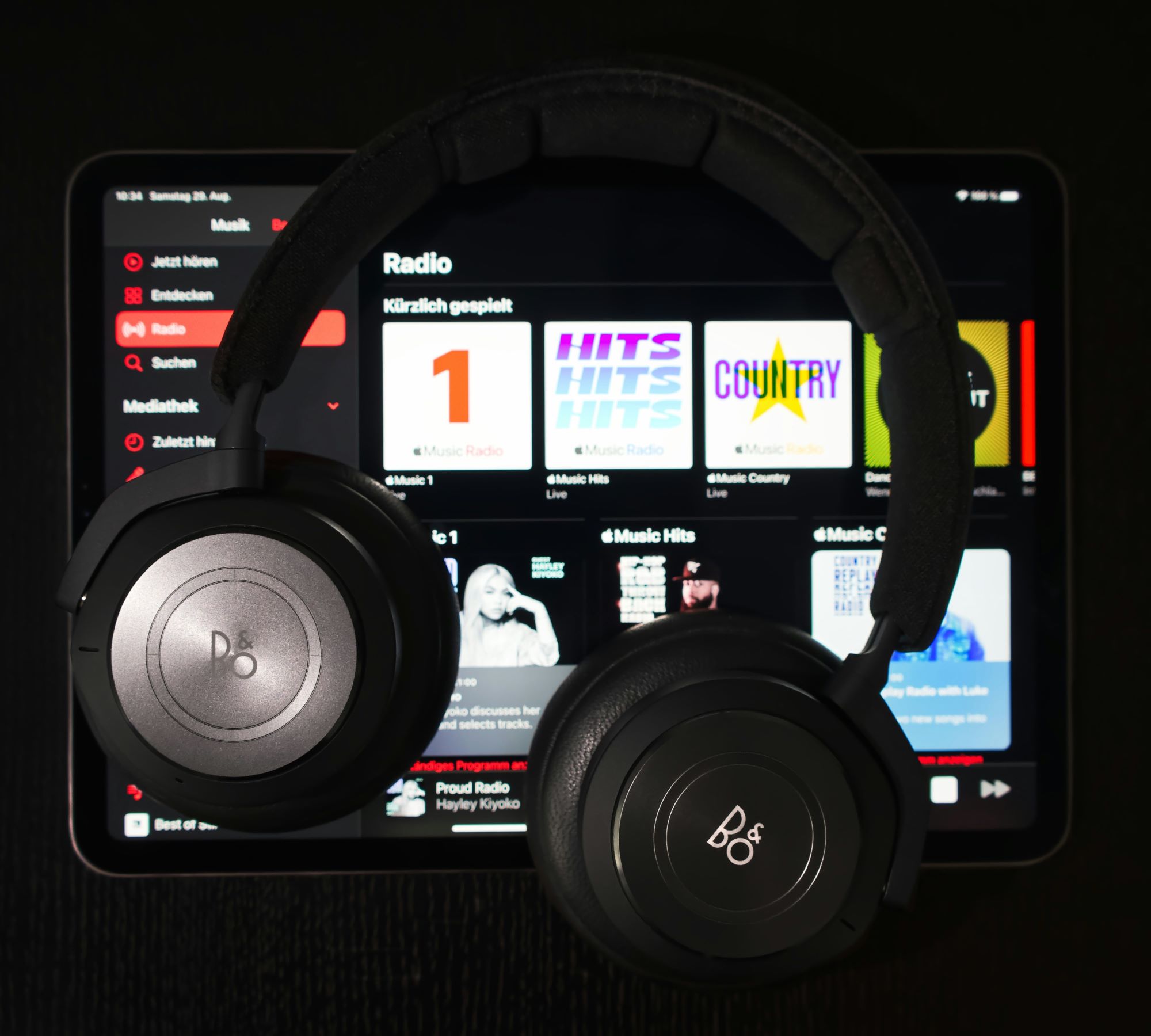 Headphones on top of iPad showing Apple Music streaming service.