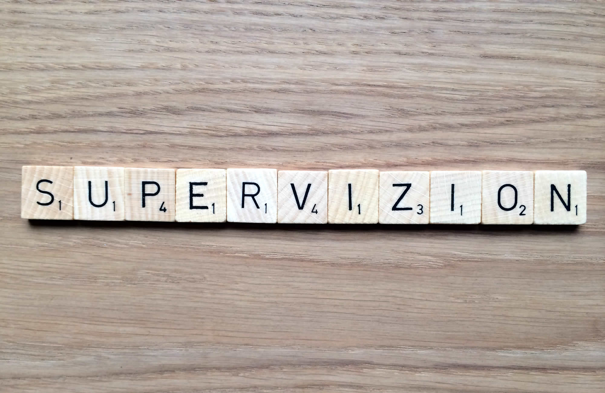 The brand name "SUPERVIZION" written in wooden letter blocks